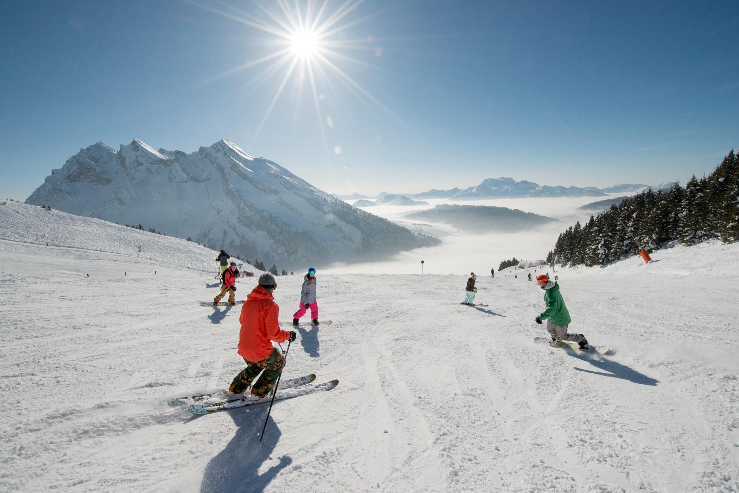 Group skiing in the sun in La Clusaz
